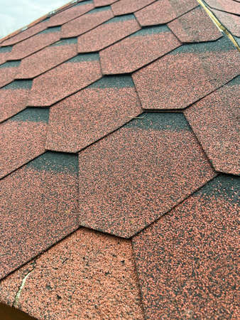 damage to the roof covering made of shingle on the gazebo in the garden