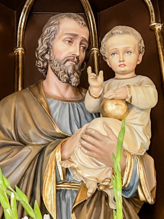 Tarnowskie GÃ³ry Strzybnica, Poland, July 01, 2023: Parish Church of the Sacred Heart of Jesus and Our Lady of Fatima in Strzybnica. Interior. Detail of the figure of St. Joseph with baby Jesus blessing.のeditorial素材