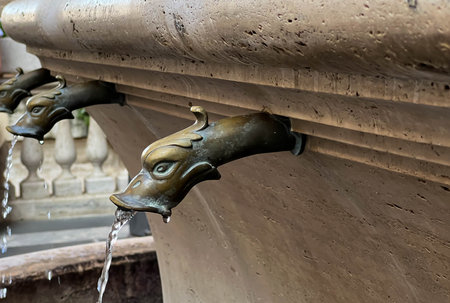 Decorative water outlets from the fountain at St. Peter's Basilica are a source of drinking water.の写真素材