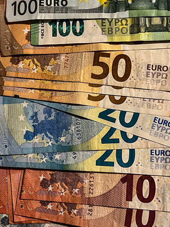 Euro banknotes of different denominations lying disorderly on the table.の写真素材