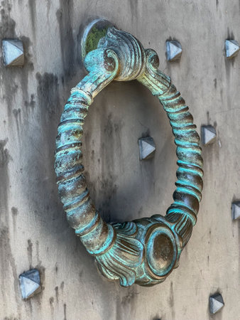 A knocker at the gate to the Benedictine Abbey of Monte Cassino in Italy. Close-up.の写真素材
