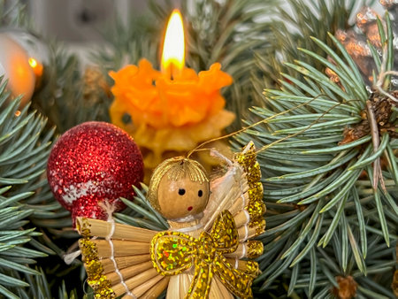 Fragment of a Christmas decoration with a candle and an angel.の写真素材