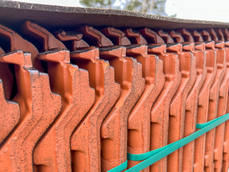 Roof tiles stacked on a pallet, visible from the side as a background.の写真素材
