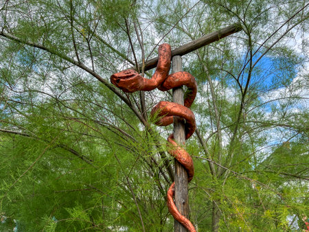 Biblical Garden in Muszyna, Poland. Biblical copper serpent on a pole.の写真素材