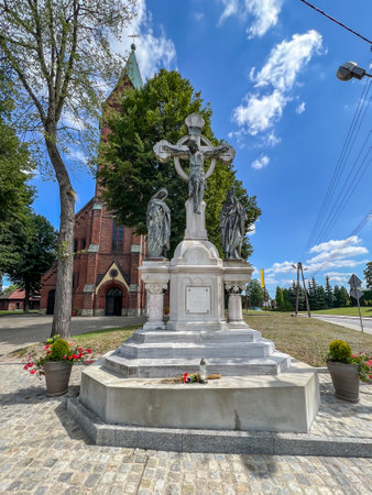 Old cross in front of the church of the Nativity of the Blessed Virgin Mary in Gliwice Bojkow, Poland.の写真素材