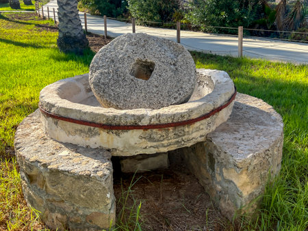 A millstone formerly used for squeezing olive oil and now used as decoration on the seaside promenade in Kissonerga, Cyprus.の写真素材