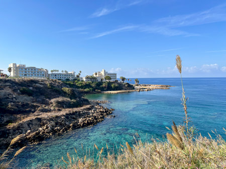 A section of the Mediterranean coast near Kissonerga, Paphos region, Cyprus, with hotels, beaches and rocks visible in the clear water.の写真素材