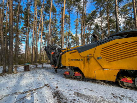 Kalety, Poland, February 17, 2025: Asphalt milling machine in a parking lot, waiting to remove part of the road surface during the construction of a sewage system.の写真素材