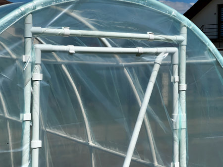 Placing a foil tunnel in a home garden to speed up the ripening of vegetables.の写真素材