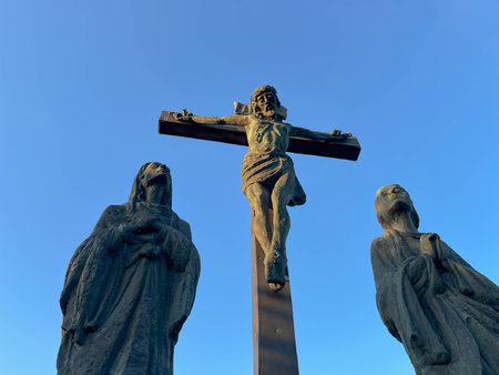 The Lord Jesus on the cross and two women under the cross in the garden at the Minor Basilica of Our Lady of Listening Patiently in Rokitno, Poland.の写真素材