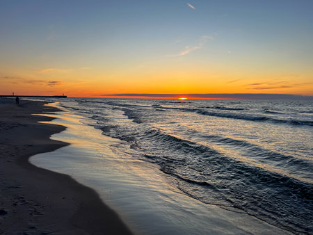 Sunset over the Baltic Sea in May, on the beach in Mrzezyno, Poland.の写真素材