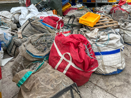 Mrzezyno, Poland, May 8, 2025: Nets and various equipment and luggage prepared for taking to fishing boats docked in the Mrzezyno port on the Baltic Sea in Poland.の写真素材