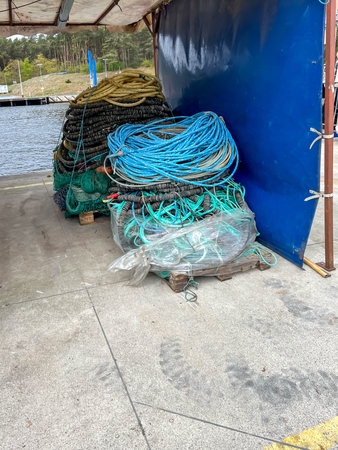 Nets and various equipment and luggage prepared for taking to fishing boats docked in the Mrzezyno port on the Baltic Sea in Poland.の写真素材