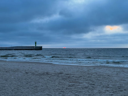 The beach and Baltic Sea near the entrance to the port in Mrzezyno in Poland.の写真素材