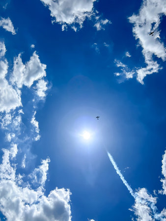 Small airplanes against a blue sky and white clouds over Piekary Slaskie in Poland.