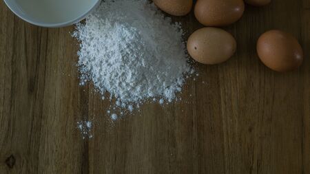 egg, milk, flour on wooden tableの写真素材