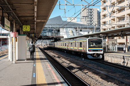 CHIBA, JAPAN - JANUARY 19 2019: The front view of the train stops and the man walking on the...