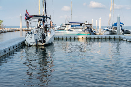CHON BURI, THAILAND - FEBRUARY 16, 2019: Eye view the small yacht club in Pattaya. The yacht, sail is parking at the pier yacht harbour on Pattaya beach, Thailand, ASEAN, South East Asiaのeditorial素材