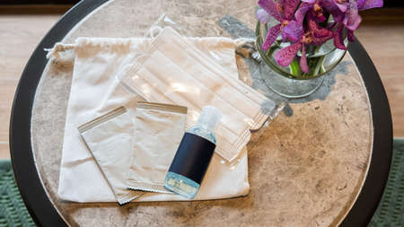 Travel kit for personal hygiene anti-covid 19 placed on a coffee table.