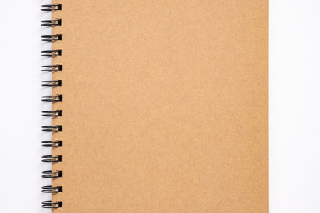 Close up, top view of brown color blank paper cover spiral notebook, copy space for your text.の写真素材