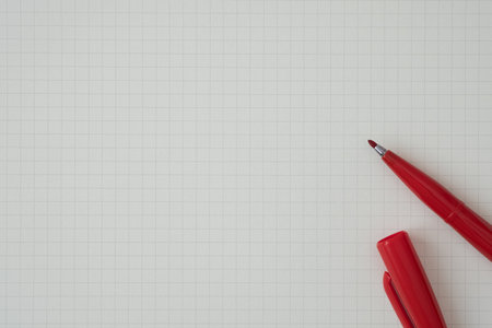 Top view, Close-up of Red Felt-tip Pen on Graph Paper, Copy Space for Text, Flat Lay Concept.の写真素材