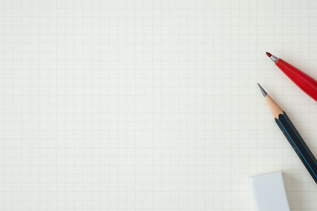 Top view, Close-up of Red Felt-tip Pen, Pencil and Eraser on Graph Paper Background, Copy Space for Text, Flat Lay Concept.の写真素材