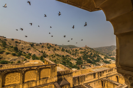 Birds flying around the Amber Fort in Jaipur, Indiaの写真素材