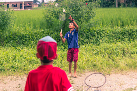 August 26, 2014 - Kids playing badminton in Sauraha, Nepalのeditorial素材
