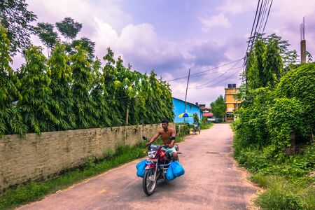 August 25, 2014 - Man riding a bike in Sauraha, Nepalのeditorial素材