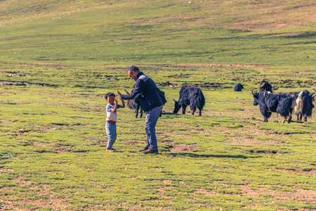 August 16, 2014 - Tourist and tibetan boy in the countryside of Tibetのeditorial素材