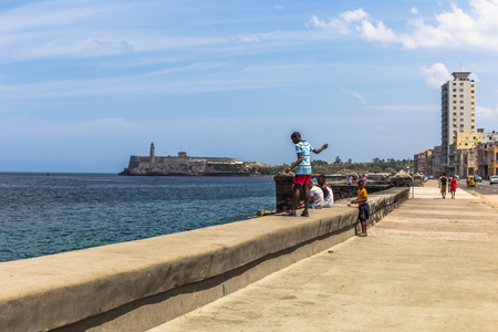 Havana, Cuba - March 27, 2016: Boy fishing in the Malecon in Havana, Cubaのeditorial素材
