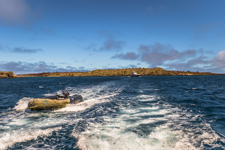 Galapagos Islands - August 24, 2017: Boat riding on the coast of Santa Cruz island, Galapagos Islands, Ecuadorのeditorial素材