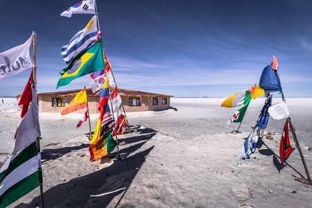Uyuni Salt Flats - July 20, 2017: Flags landmark at the Uyuni Salt Flats, Boliviaのeditorial素材