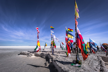 Uyuni Salt Flats - July 20, 2017: Flags landmark at the Uyuni Salt Flats, Boliviaのeditorial素材