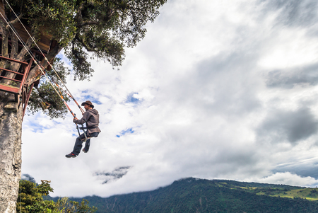 Baños - August 19, 2018: Tourists riding the famous Casa de Arbol End of the World swing in Baños, Ecuadorのeditorial素材