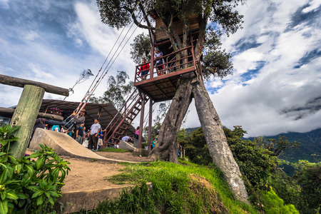 Baños - August 19, 2018: Tourists riding the famous Casa de Arbol End of the World swing in Baños, Ecuadorのeditorial素材