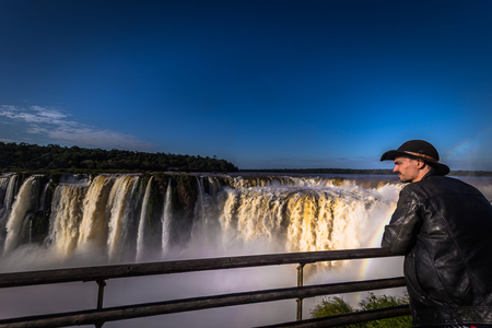 Puerto Iguazu - June 24, 2017: Traveller at the Devil's Throat site at the Iguazu Waterfalls, Wonder of the world, at Puerto Iguazu, Argentinaのeditorial素材