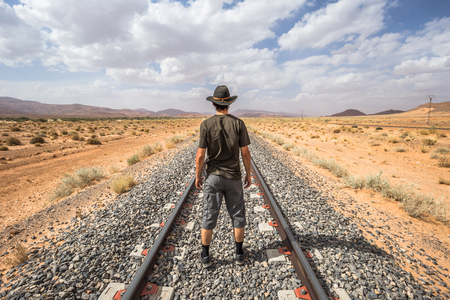 Western traveler on railway tracks on the countryside of Algeriaの写真素材