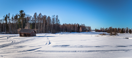 Dalarna - March 30, 2018: Lone wooden house in the cold wilderness of Dalarna, Swedenのeditorial素材