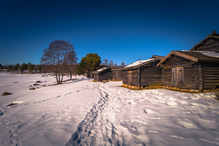 Rattvik - March 30, 2018: Wooden houses by the frozen lake Siljan in Rattvik, Dalarna, Swedenのeditorial素材