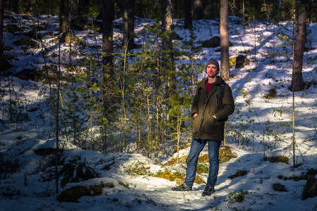 Falun - March 31, 2018: Traveler hiking on the frozen lake at Framby Udde near the town of Falun in Dalarna, Swedenのeditorial素材