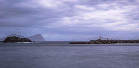Henningsvaer- June 15, 2018: Distant lighthouse of a small village in the Lofoten Islands, Norway