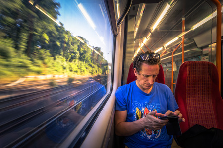 London - August 05, 2018: Young man traveling on a train in London, Englandのeditorial素材