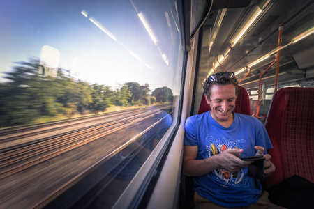 London - August 05, 2018: Young man traveling on a train in London, Englandのeditorial素材