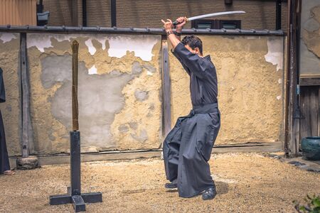 Kyoto - May 29, 2019: Western traveler practicing Iaido sword fighting in a Samurai Experience event in Kyoto, Japanのeditorial素材