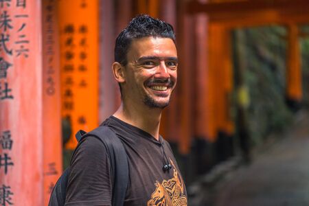 Kyoto - May 28, 2019: Western traveler in the Torii gates of the Fushimi Inari Shinto shrine in Kyoto, Japanのeditorial素材