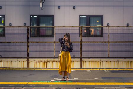 Osaka - June 01, 2019: Japanese girl waiting for a train in Osaka, Japanのeditorial素材