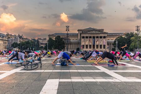 Budapest - June 21, 2019: Yoga event at dawn in Heroes Square in Budapest, Hungary