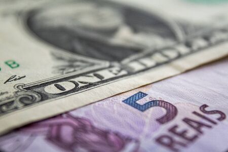 US dollar bill and Brazilian reais banknotes, business finance exchange market.