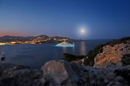 Coast line with superyacht in Ibiza at nightの写真素材